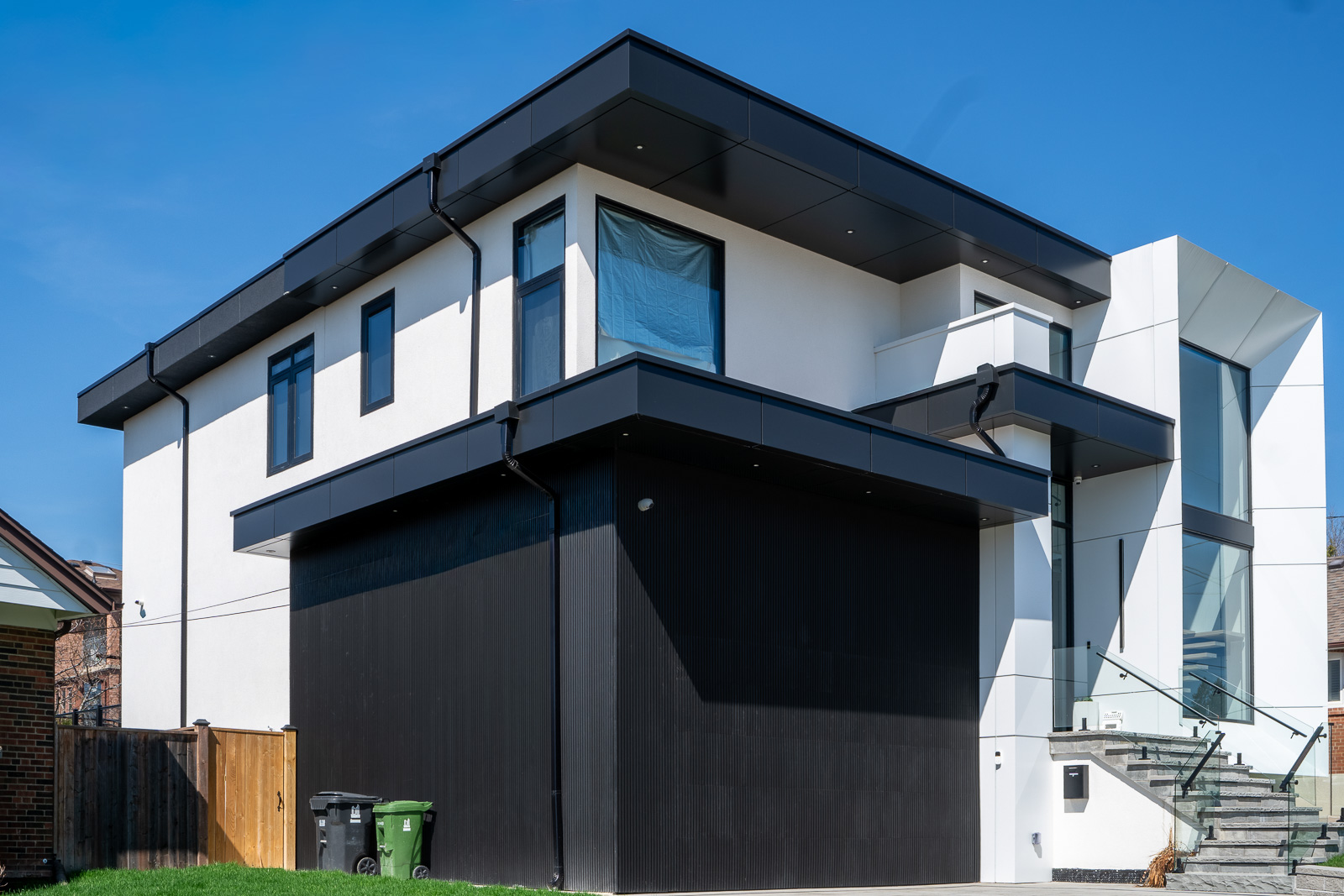 61 Deevale Rd modern residential facade with Midnight Black ACM garage cladding, Off-White ACM returns, glass railing, and contemporary exterior detailing.