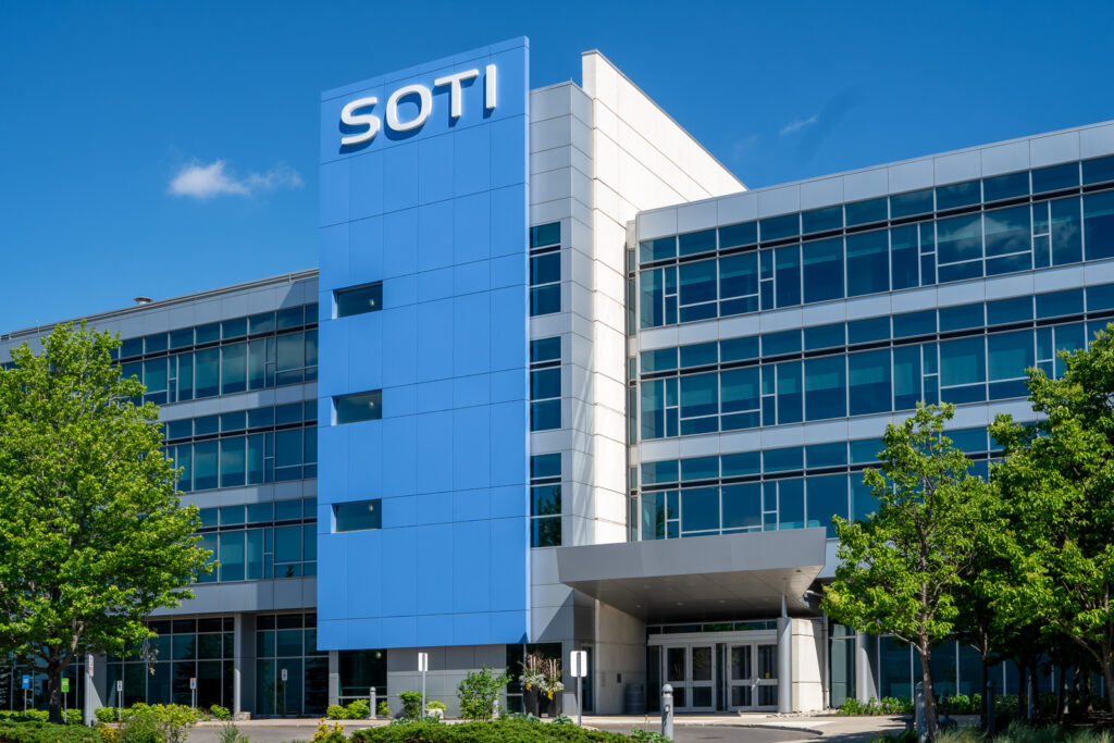 SOTI Mississauga commercial building facade with blue ACM tower, glass curtain wall, and entrance canopy.
