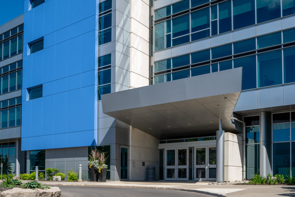 Blue ACM panel tower and entrance canopy detail at SOTI Mississauga commercial office building.