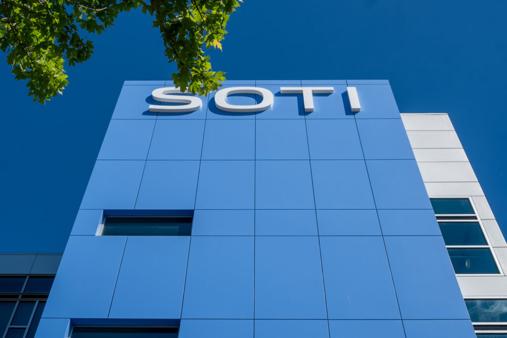 Close view of SOTI blue ACM tower showing panel layout, joint alignment, and signage area.